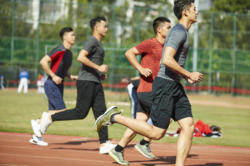 young asian athletes running on track