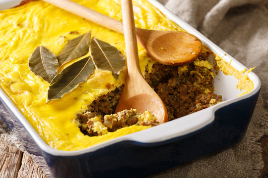 South African traditional food Bobotie baked curry ground meat with whipped eggs close-up. horizontal