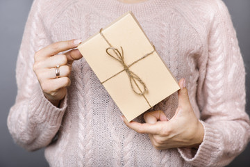 Woman with wrapped present in hands
