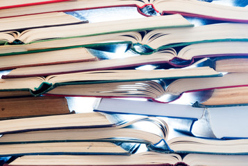 a lot of opened old and used hardback books or text books. Books and reading are essential for self...