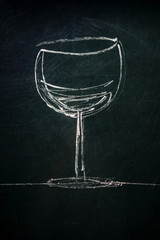 A photo of a simple drawing of a glass of wine, made with chalk on a blackboard, with a place for...