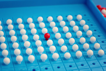 Naklejka premium Unique red pin among many white ones. Stand out of crowd, individuality, difference and leadership concept