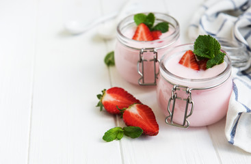 Jars with strawberry yogurt