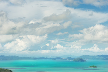 Seascape of phuket island..Tropical island in andaman blue sea with fluffy cloudy blue sky and sunlight..