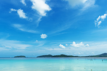 Fototapeta na wymiar Tranquil seascape in sunny day..Tropical blue sea and cloudy blue sky at andaman seashore in summertime,wide angle view. .