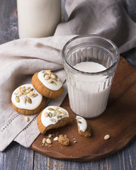 Christmas gingerbread with nuts and seeds with milk on a wooden table. Delicious homemade treat for children and Santa Claus
