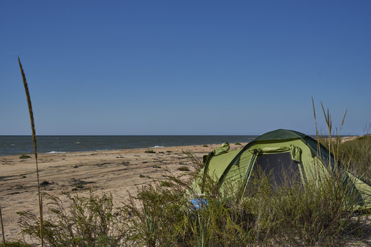 Image of a tent on a sandy beach.