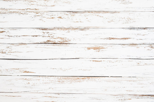 Wood plank painted in white weathered and old. Vintage and rustic white wooden background.