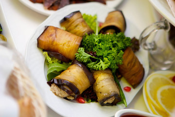 A dish of toppings, wrapped in fried eggplant.