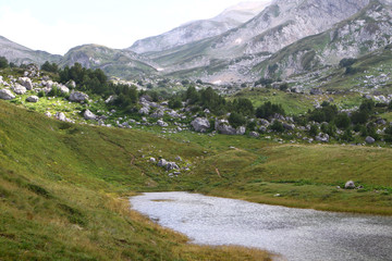 Fototapeta na wymiar Natural landscape photo of small fantastic lake Psenodah in North Caucasus at Fisht and Oshten mountains