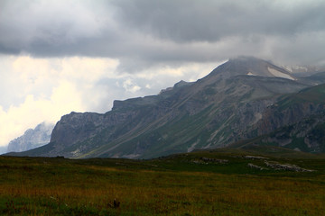 Fototapeta na wymiar cute nordic mountain landscape with heavy clouds, natural landscape photo