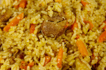 Pilaf with meat, rice, carrot and onion. Close-up