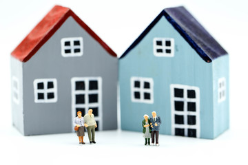 Miniature people: Couple of Oldmans standing with house, money saving growth. Retirement, emergency plan and Financial Concept.