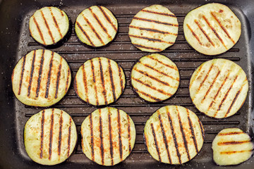 Background of grilled chopped by circles eggplants on grill pan © An-T