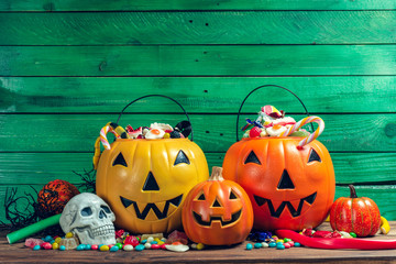 Happy halloween! Pumpkin with candy in the home.