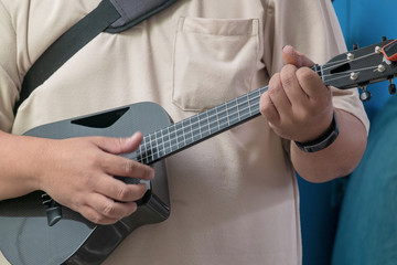 Professional Musician Playing Modern Ukulele Guitar in the Outdoor Mini Concert