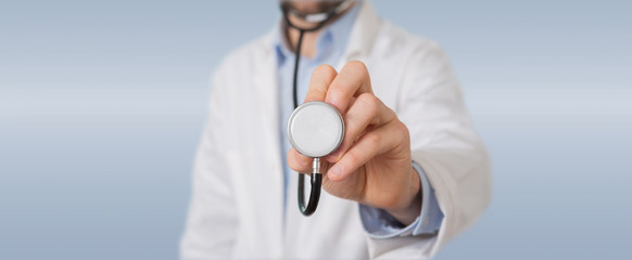 Doctor using stethoscope in hospital - obrazy, fototapety, plakaty
