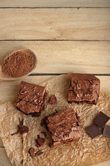 Homemade brownies on wooden background top view