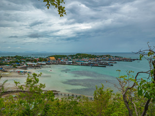 ViewPoint on the mountain with Fisherman townscape with idyllic ocean and rainy cloud sky in vacation time,Chonburi thailand,holiday concept