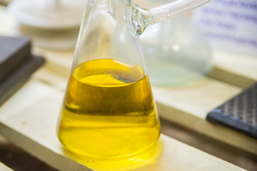 Flask with yellow liquid in industrial laboratory