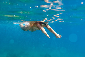 Woman snorkeling in the clear sea water