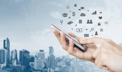 Mobile phone application and technology. Hand using mobile smart phone and city background