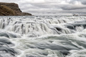 Gullfoss waterfall located in canyon river southwest Iceland. River rapid waterfall. Water stream flow. Waterfall nature landscape. Tourist destinations concept. Waterfall popular tourist attraction