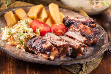 Spicy barbecued pork ribs with french fries