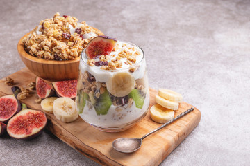Granola with yogurt, bananas and figs. Copy space