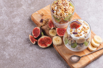 Granola with yogurt, bananas and figs. Copy space
