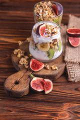 Granola with yogurt, bananas and figs. Copy space