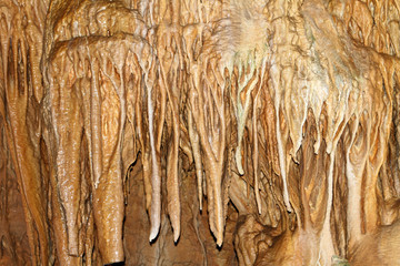 Natural texture image of nice natural cave with light brown walls and formations of stalagmites within - Marble Cave, Crimea