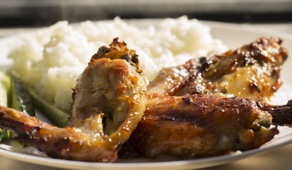 fried chicken wings on plate served with rice close up