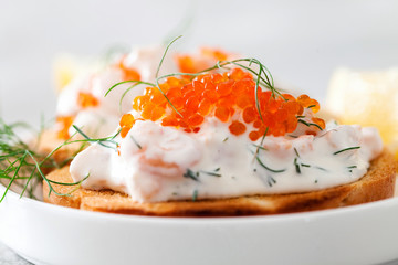 Toast skagen - shrimp and caviar on toast. Classic swedish appetizer. Selective focus.