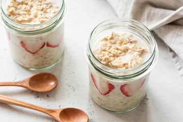 Overnight oats or oatmeal in a jar on concrete background. Healthy eating, healthy lifestyle concept