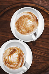Two cups of cappuccino coffee, top view