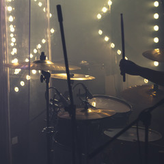 Drum set with cymbals and drummer hand