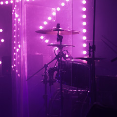 Live music photo, rock drum set in lights