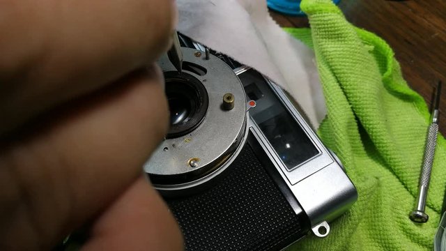 The footage close up hand repair vintage camera film 135 mm. 