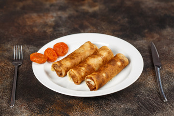 Crepes stuffed with cottage cheese and dried apricots