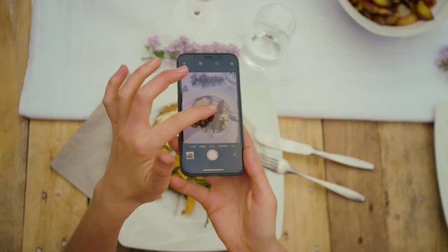 Woman taking a photo of her food 