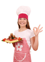 happy little girl cook with spaghetti and meatballs and ok hand sign