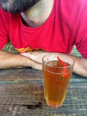man with chilli beer