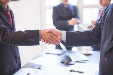 After meeting business people shaking hands with new partner meeting  to jointly invest in business together.