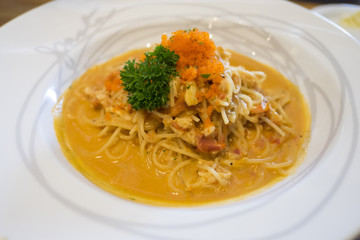 Close up of seafood spaghetti in white plate. Spaghetti with crab and shrimp sauce.
