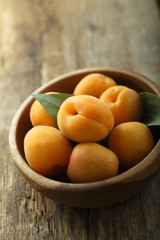 Fresh apricots in the wooden bowl