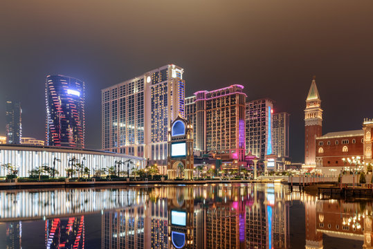 Night view of modern buildings reflected in water, Cotai, Macau