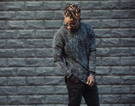 African american man model wear stylish fashionable pullover standing against brick wall