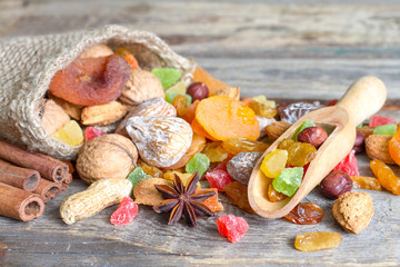 Dried fruits and nuts organic healthy snacks on old planks 
