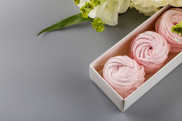 Set of handmade pink zephyr or marshmallow in white box with flowers